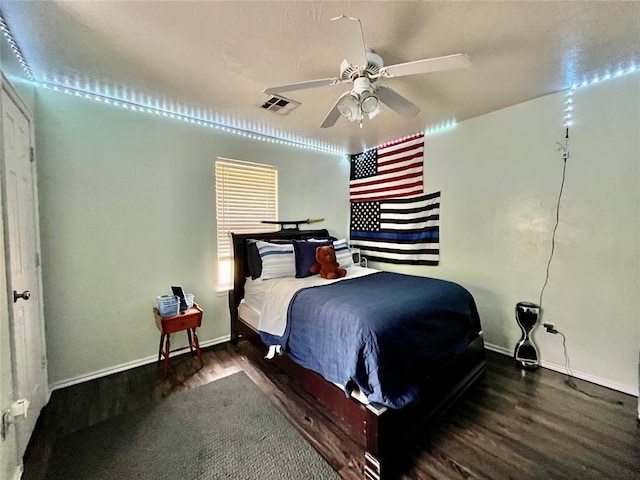 bedroom featuring wood finished floors, baseboards, and ceiling fan