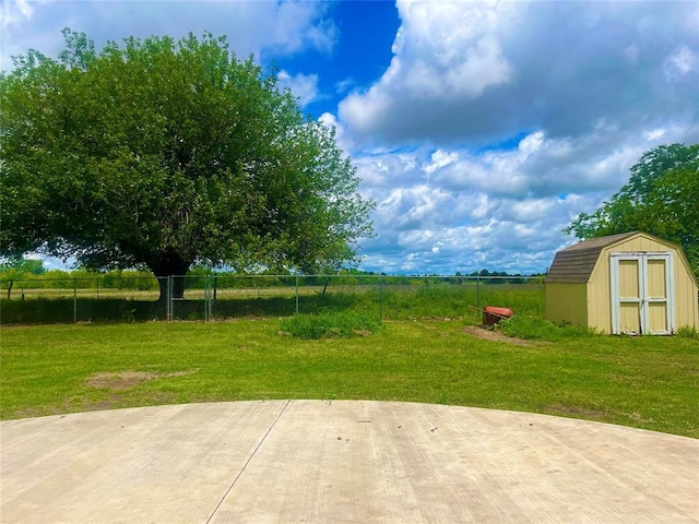 view of yard with a storage unit, a patio, and an outbuilding