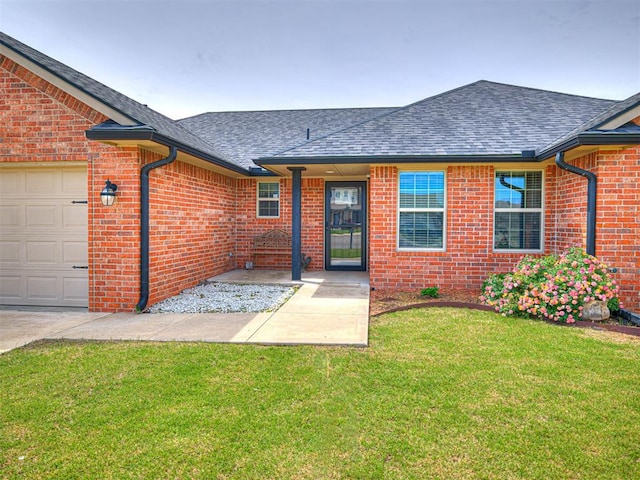 view of front facade with roof with shingles, brick siding, a front lawn, and a garage