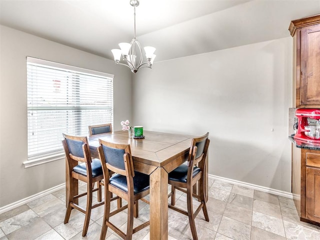 dining area with baseboards, a chandelier, and plenty of natural light