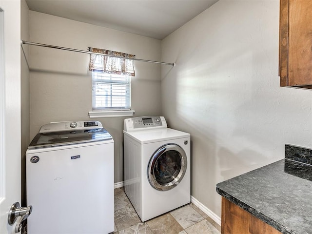washroom with separate washer and dryer, baseboards, and light stone finish flooring