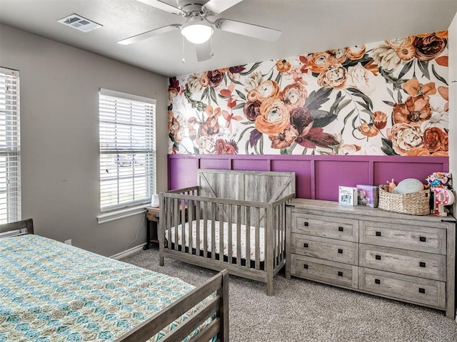 carpeted bedroom featuring baseboards and a ceiling fan