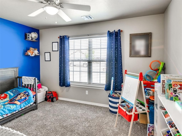 carpeted bedroom featuring baseboards and a ceiling fan