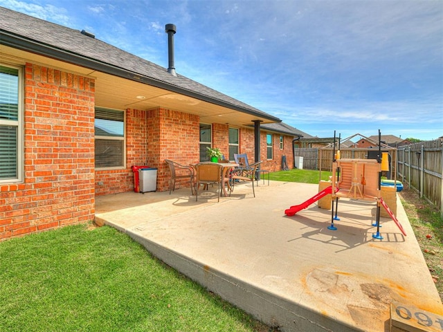 view of patio featuring a fenced backyard and a playground