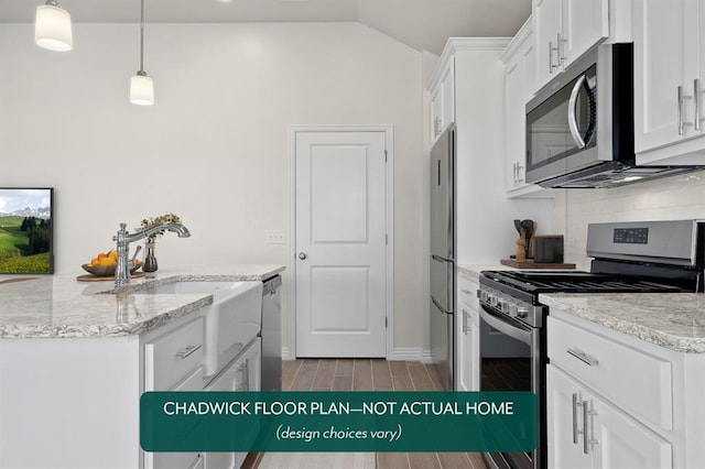 kitchen featuring appliances with stainless steel finishes, decorative backsplash, white cabinets, wood finish floors, and lofted ceiling