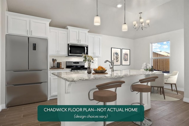 kitchen with appliances with stainless steel finishes, dark wood-style flooring, baseboards, white cabinets, and vaulted ceiling