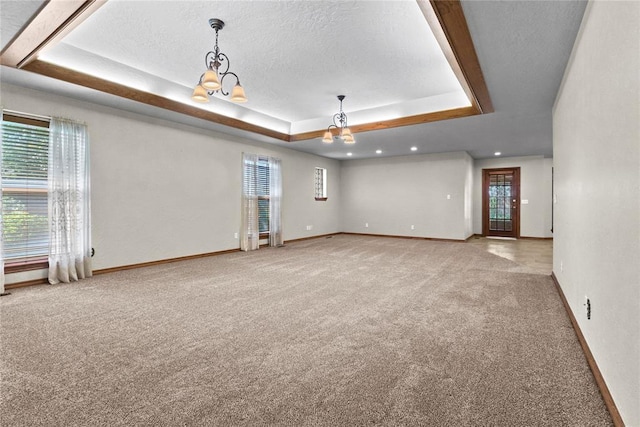2001 Saber Ln, Weatherford, OK 73096 - carpeted spare room featuring a chandelier, a raised ceiling, baseboards, recessed lighting, and a textured ceiling
