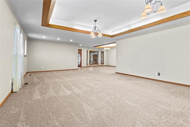 2001 Saber Ln, Weatherford, OK 73096 - carpeted spare room featuring a chandelier, a raised ceiling, baseboards, and recessed lighting