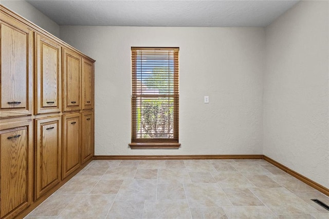 2001 Saber Ln, Weatherford, OK 73096 - unfurnished bedroom featuring baseboards