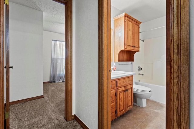 2001 Saber Ln, Weatherford, OK 73096 - bathroom featuring toilet, vanity, shower / tub combination, and a textured wall