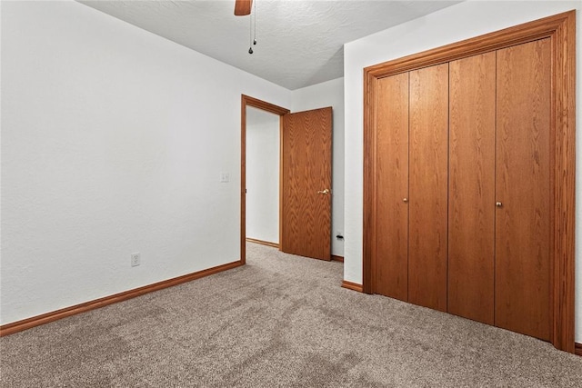2001 Saber Ln, Weatherford, OK 73096 - unfurnished bedroom featuring carpet floors, baseboards, a closet, ceiling fan, and a textured ceiling