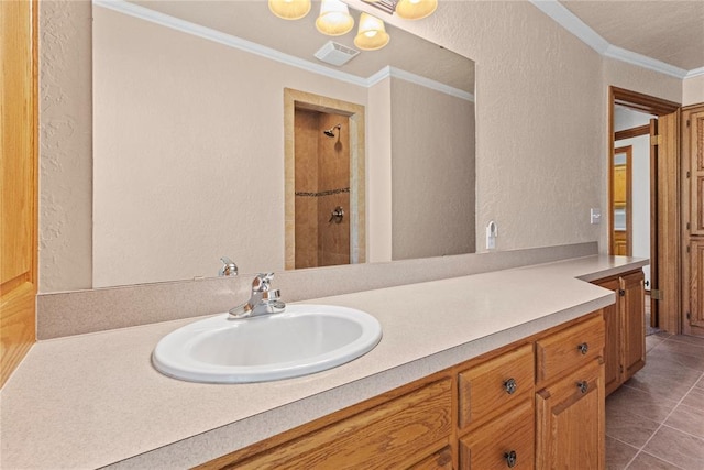 2001 Saber Ln, Weatherford, OK 73096 - full bath with ornamental molding, a textured wall, vanity, tiled shower, and tile patterned floors