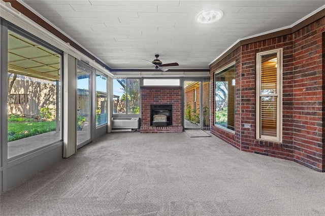 2001 Saber Ln, Weatherford, OK 73096 - unfurnished sunroom featuring an outdoor brick fireplace, a ceiling fan, and plenty of natural light