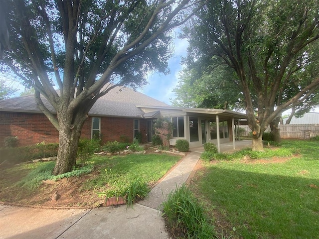 2001 Saber Ln, Weatherford, OK 73096 - view of front of house featuring brick siding, a patio, and roof with shingles