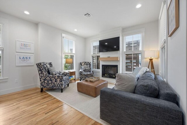 43 Center Ln, Carlton Landing, OK 74432 - living room featuring a fireplace, light wood-style floors, baseboards, and recessed lighting