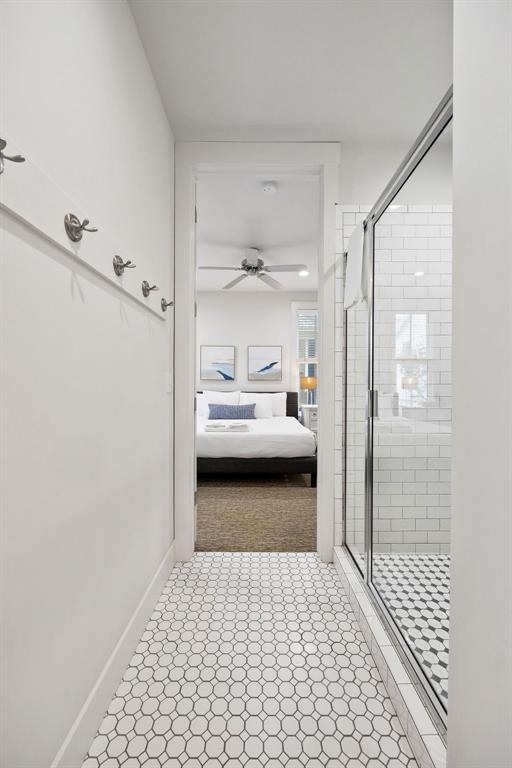 43 Center Ln, Carlton Landing, OK 74432 - bathroom featuring connected bathroom, a shower stall, a ceiling fan, and baseboards