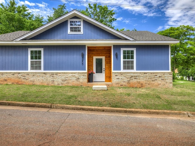 1800 NW 41st St, Oklahoma City, OK 73118 - view of front facade with brick siding, a front yard, and a shingled roof