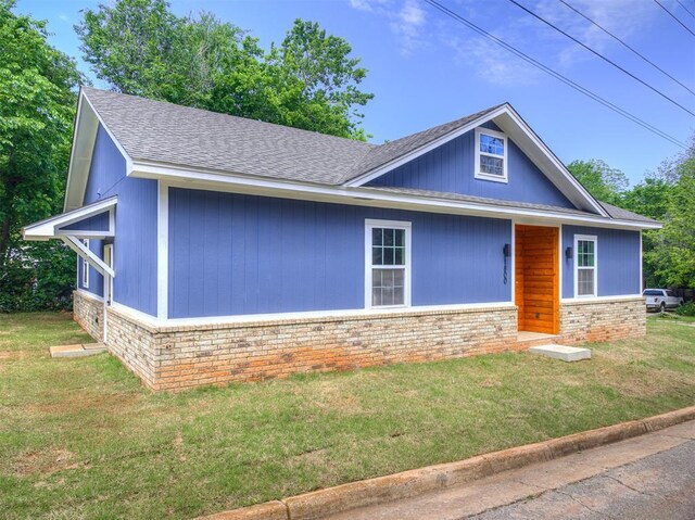 1800 NW 41st St, Oklahoma City, OK 73118 - view of front of house featuring brick siding, a front lawn, and a shingled roof