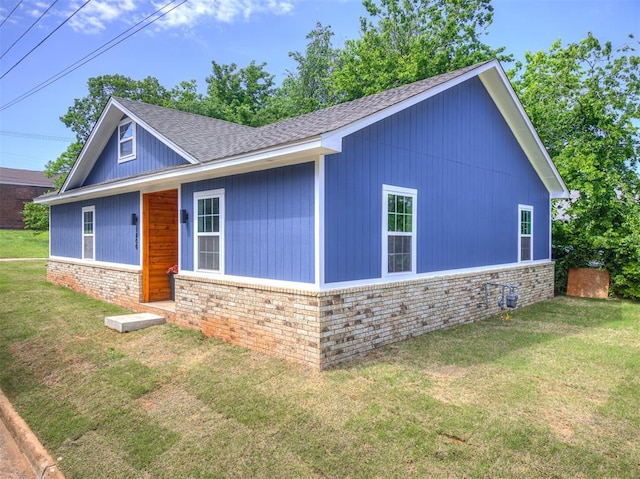 1800 NW 41st St, Oklahoma City, OK 73118 - view of home's exterior with a lawn, brick siding, and roof with shingles