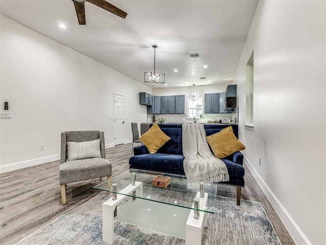 1800 NW 41st St, Oklahoma City, OK 73118 - living area featuring light wood-style floors, baseboards, a ceiling fan, recessed lighting, and a chandelier