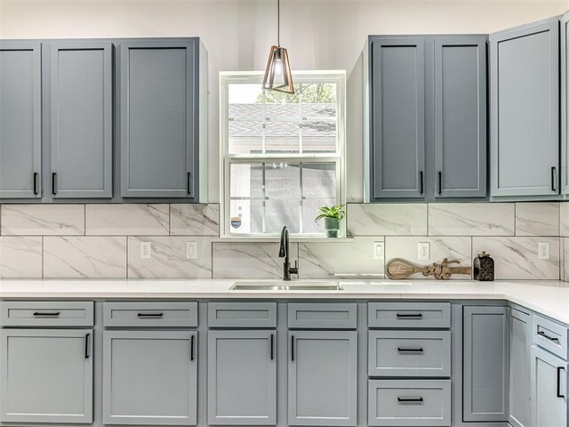 1800 NW 41st St, Oklahoma City, OK 73118 - kitchen with a sink, gray cabinetry, decorative backsplash, and light countertops