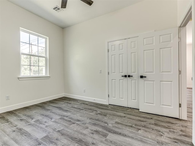 1800 NW 41st St, Oklahoma City, OK 73118 - unfurnished bedroom featuring wood finished floors, a closet, baseboards, and a ceiling fan