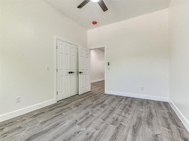 1800 NW 41st St, Oklahoma City, OK 73118 - unfurnished bedroom featuring wood finished floors, baseboards, a ceiling fan, a closet, and lofted ceiling