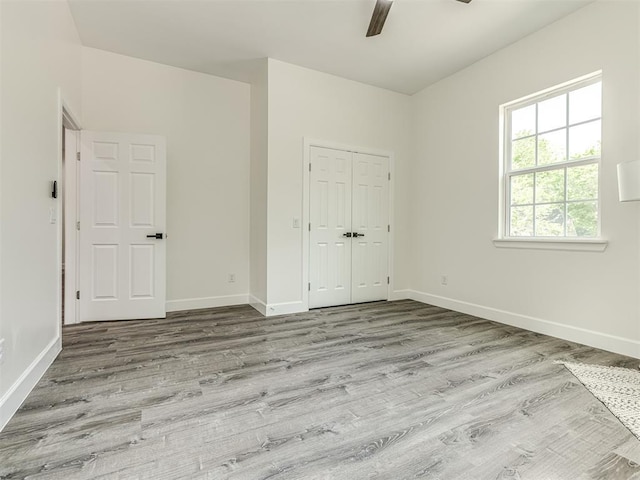 1800 NW 41st St, Oklahoma City, OK 73118 - unfurnished bedroom featuring wood finished floors, baseboards, a closet, and ceiling fan