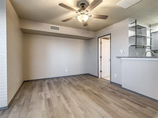 11530 N May Ave Unit D303, Oklahoma City, OK 73120 - spare room featuring ceiling fan, light wood-style flooring, and baseboards
