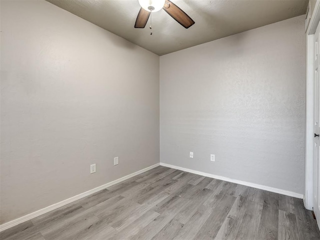 11530 N May Ave Unit D303, Oklahoma City, OK 73120 - empty room with a ceiling fan, wood finished floors, and baseboards