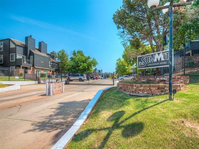 11530 N May Ave Unit D303, Oklahoma City, OK 73120 - view of concrete street with a gate, a gated entry, and curbs