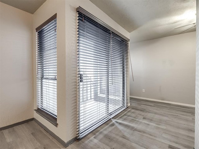 11530 N May Ave Unit D303, Oklahoma City, OK 73120 - hallway featuring wood finished floors and baseboards