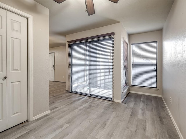 11530 N May Ave Unit D303, Oklahoma City, OK 73120 - spare room with ceiling fan, light wood finished floors, and a textured wall
