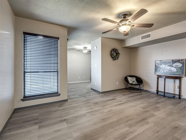 11530 N May Ave Unit D303, Oklahoma City, OK 73120 - spare room featuring ceiling fan, wood finished floors, and a textured ceiling