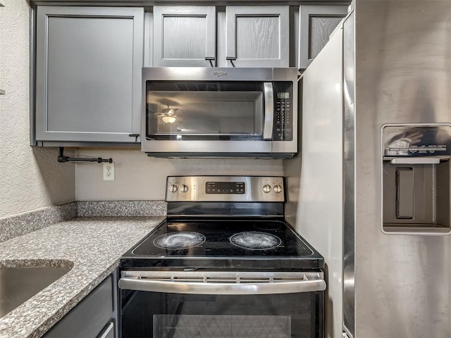 11530 N May Ave Unit D303, Oklahoma City, OK 73120 - kitchen with stainless steel appliances and gray cabinets