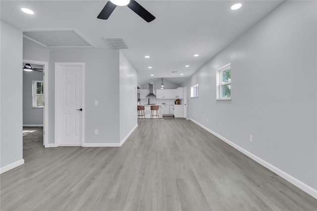 unfurnished living room with ceiling fan, light wood-style floors, recessed lighting, and baseboards