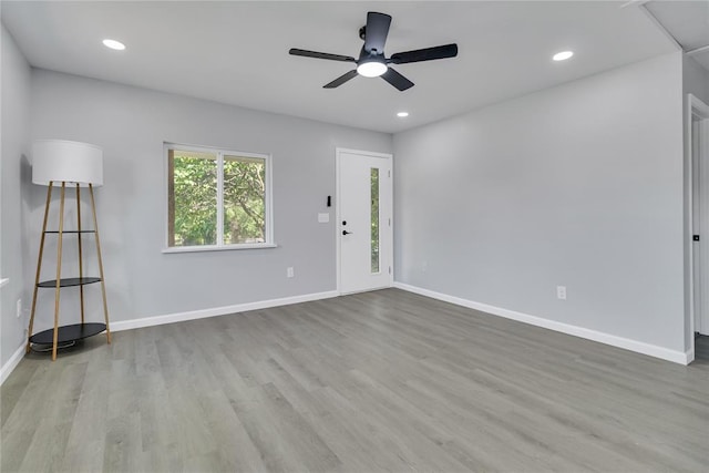 unfurnished living room with a ceiling fan, wood finished floors, baseboards, and recessed lighting