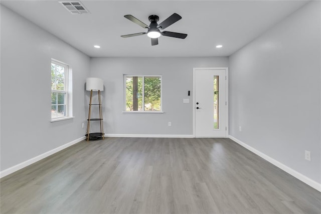 empty room with ceiling fan, wood finished floors, baseboards, and recessed lighting