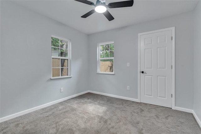 unfurnished room featuring carpet floors, ceiling fan, and baseboards