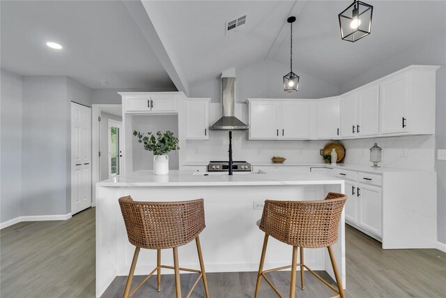 kitchen featuring wall chimney exhaust hood, wood finished floors, electric range, and lofted ceiling