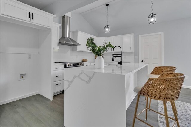 kitchen with wall chimney exhaust hood, a sink, dark wood-style floors, light stone countertops, and white cabinetry