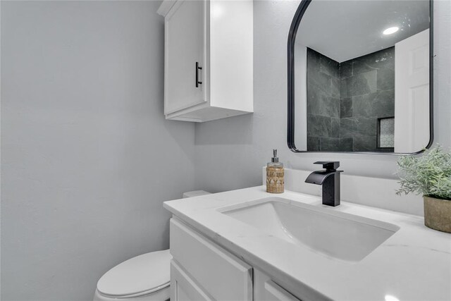 bathroom featuring toilet and vanity