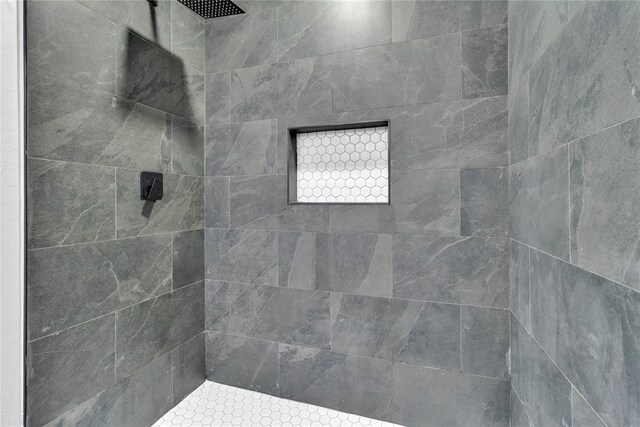 bathroom with a tile shower
