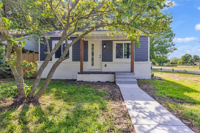 bungalow-style home with brick siding and a porch