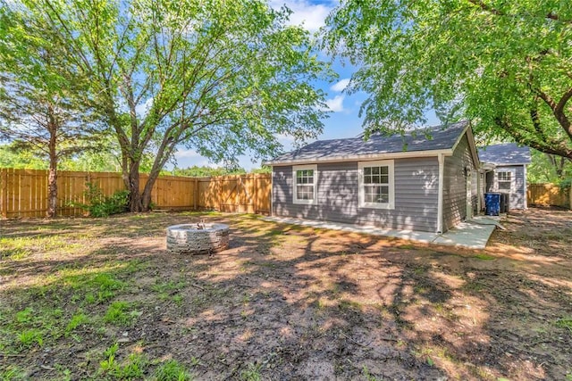 fenced backyard with an outdoor fire pit
