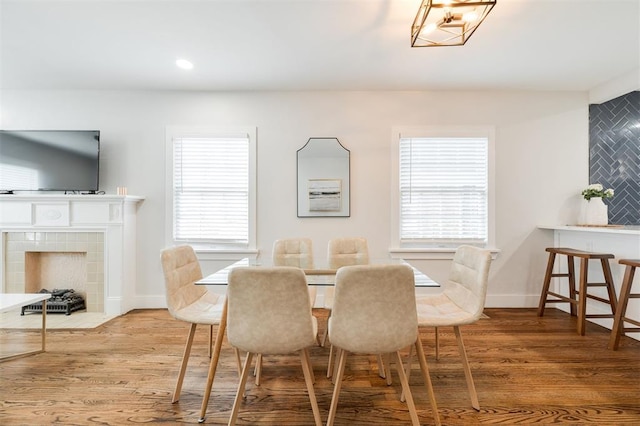 2237 NW 30th St, Oklahoma City, OK 73112 - dining space featuring wood finished floors, a fireplace, healthy amount of natural light, baseboards, and recessed lighting