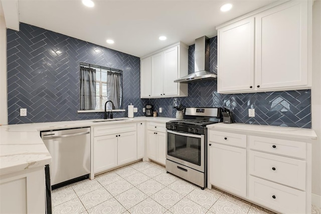 2237 NW 30th St, Oklahoma City, OK 73112 - kitchen featuring wall chimney exhaust hood, appliances with stainless steel finishes, a sink, decorative backsplash, and white cabinets