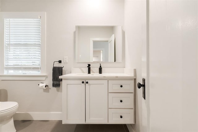 2237 NW 30th St, Oklahoma City, OK 73112 - bathroom with vanity, baseboards, and toilet