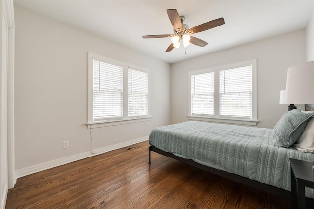 2237 NW 30th St, Oklahoma City, OK 73112 - bedroom with baseboards, wood finished floors, and a ceiling fan