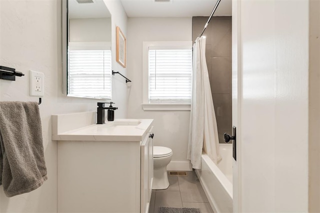2237 NW 30th St, Oklahoma City, OK 73112 - full bath with tile patterned flooring, vanity, toilet, baseboards, and shower / bath combo